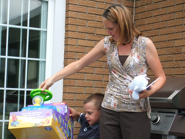 His big brother, Will, is helping Mom out with the gifts.